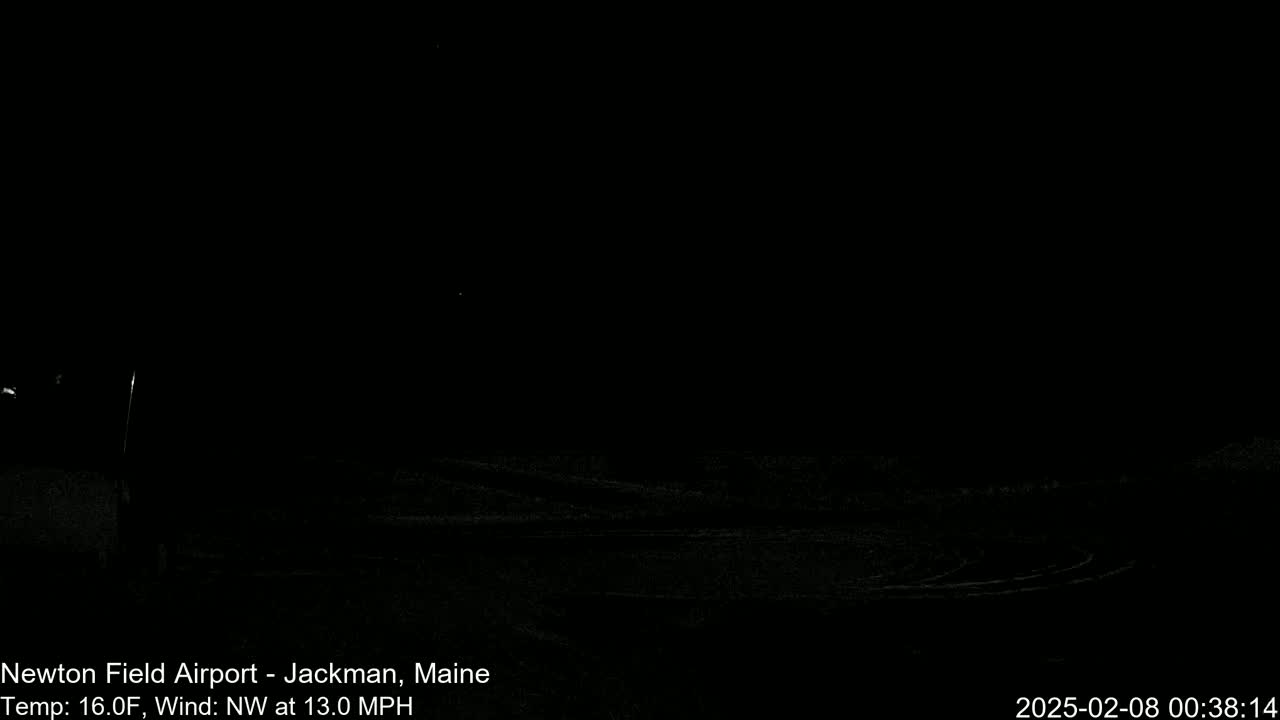 A dark, nighttime image shows a snow-covered landscape under a clear sky with a northwest wind at 13 mph and a temperature of 16°F.