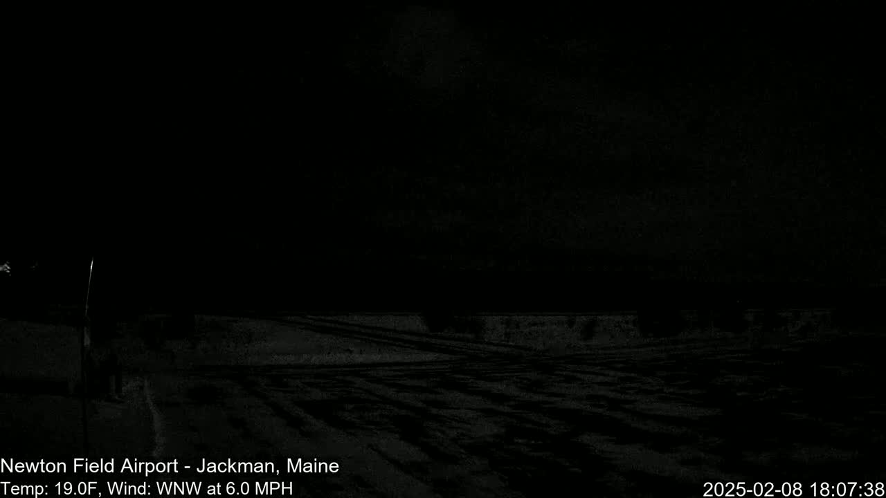 A dark, nighttime scene of a snow-covered expanse under a mostly clear sky with a 6.0 mph wind and a temperature of 19°F.