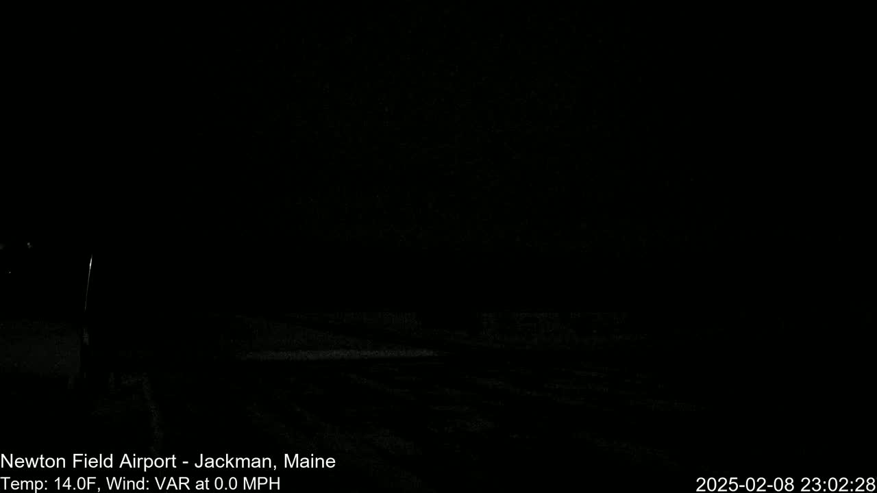 A dark, nighttime scene of a snow-covered ground with a calm wind and a temperature of 14 degrees Fahrenheit.