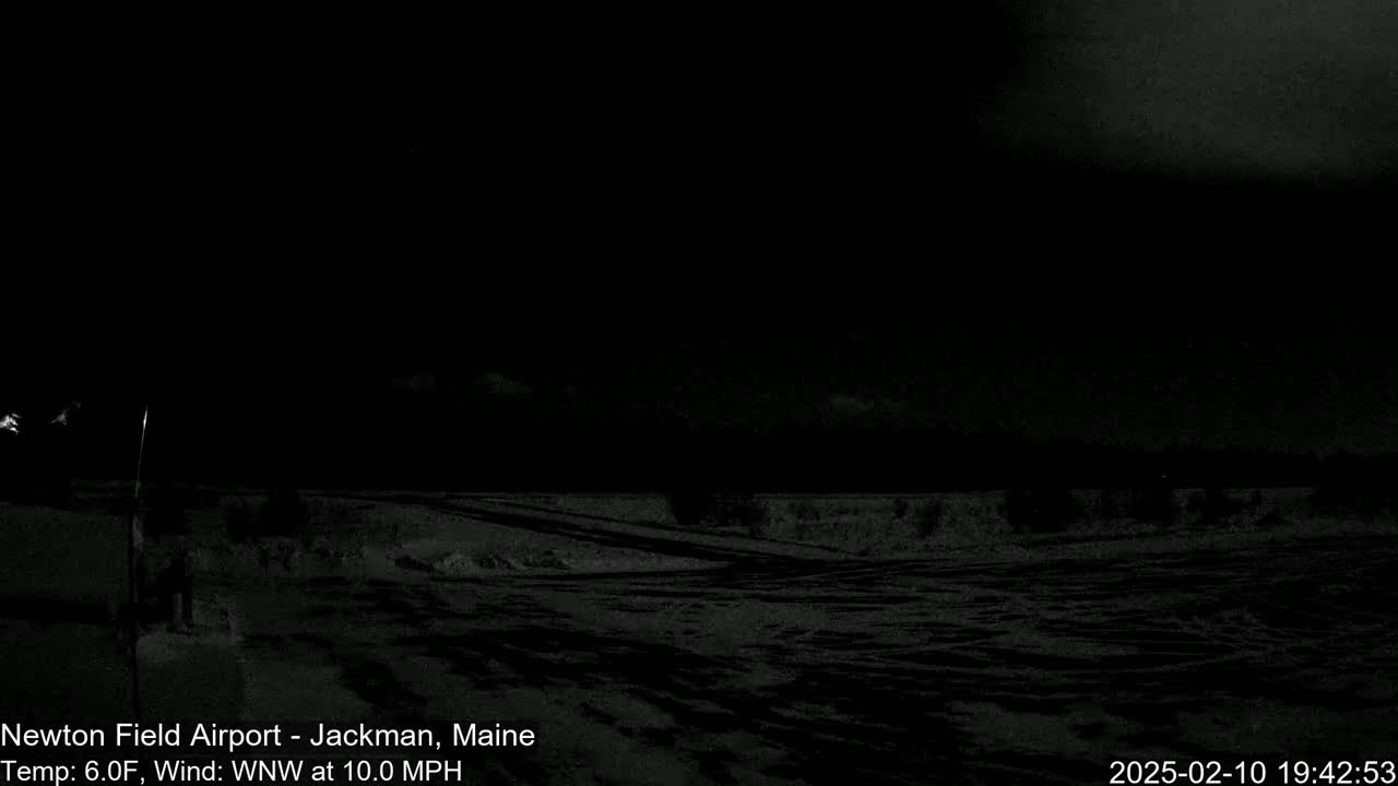 A snow-covered field is visible at night under a dark sky, with a wind blowing from the west-northwest at 10 mph.