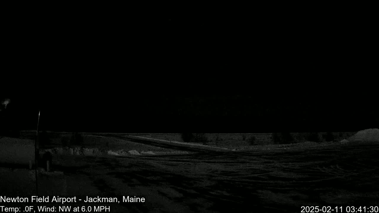 A dark, snowy landscape is visible at night under a clear sky, with a northwest wind blowing at 6.0 mph.