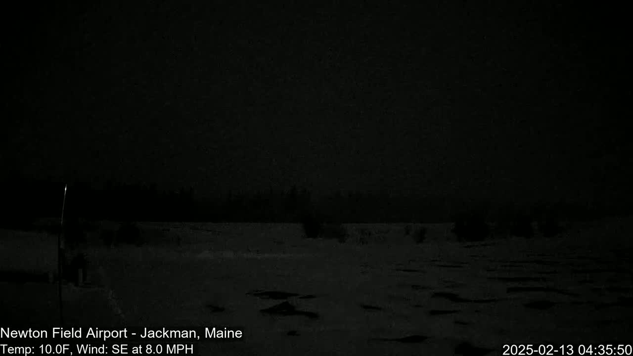 A dark, snowy landscape is visible at night under a dark sky, with a slight southeast wind.