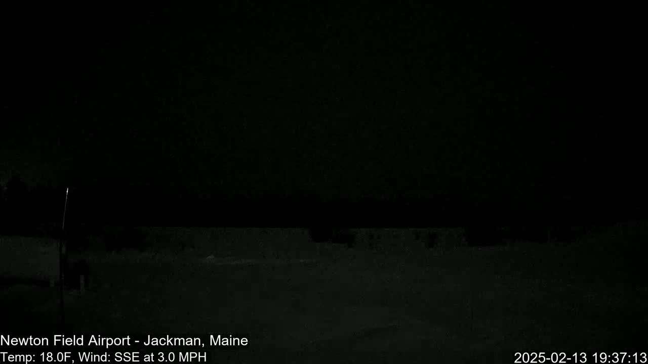 A dark, nighttime scene shows a flat, snow-covered ground under a black sky with a wind of 3.0 mph from the south-southeast at a temperature of 18°F.
