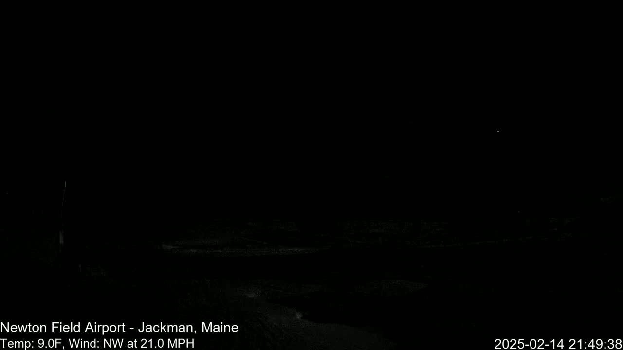 A dark, nighttime outdoor scene with a northwest wind at 21 mph and a temperature of 9°F.