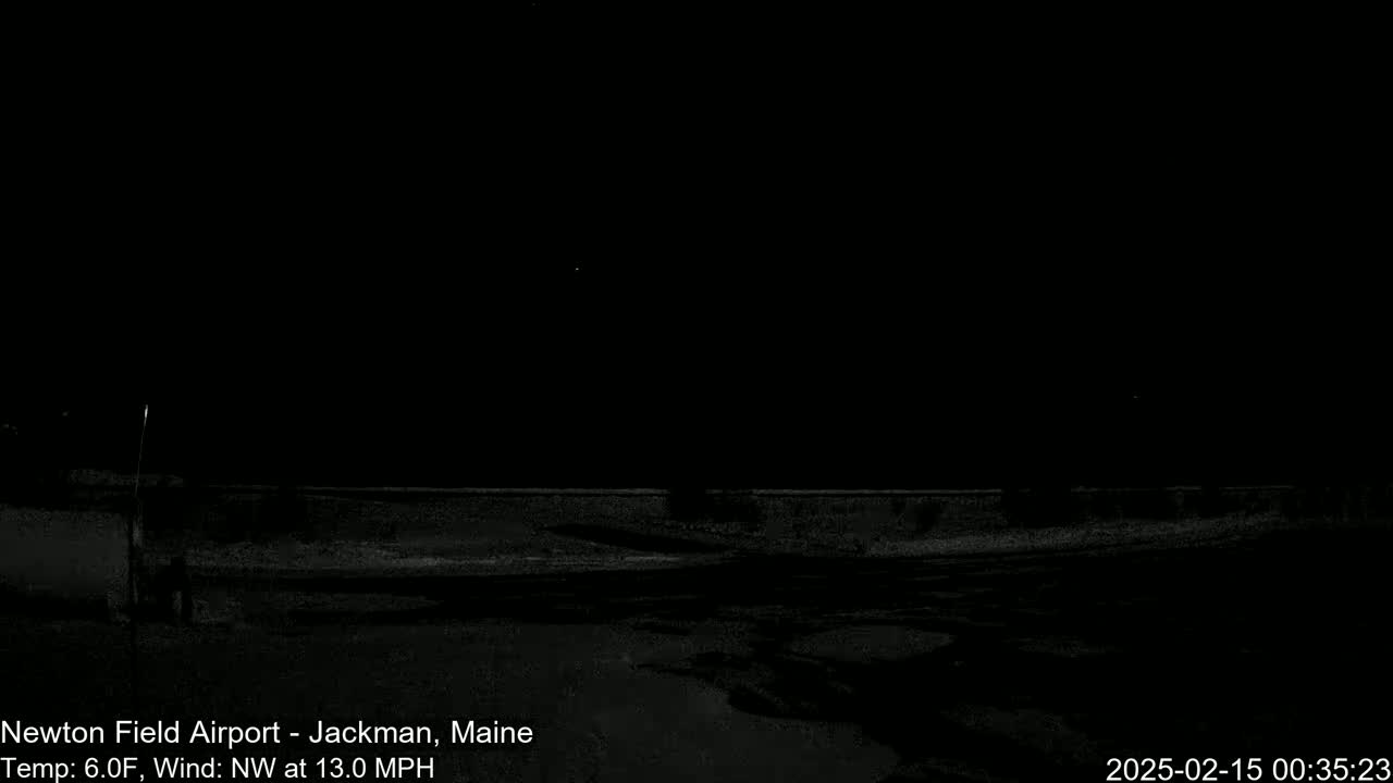 A dark, nighttime scene shows a low wall and flat ground under a clear, dark sky with a northwest wind blowing at 13 mph and a temperature of 6°F.