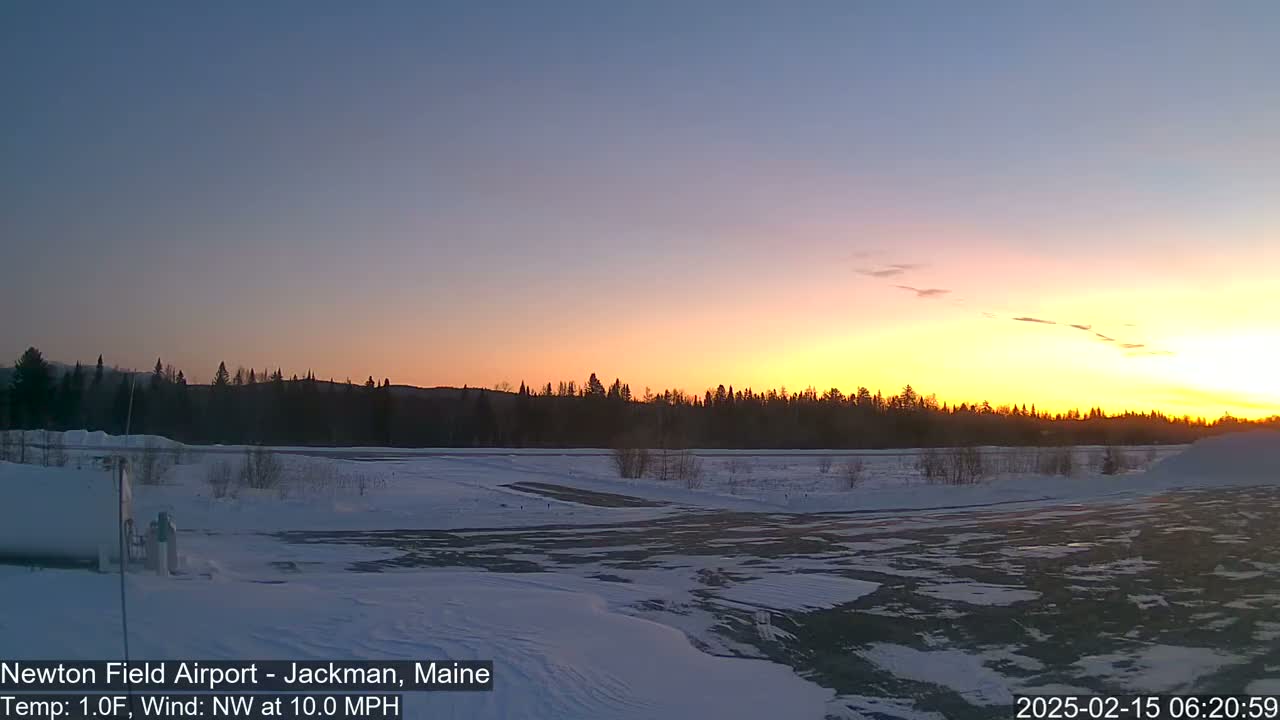 A snow-covered airfield at sunrise, with a northwest wind blowing at 10 mph and a temperature of 1 degree Fahrenheit.
