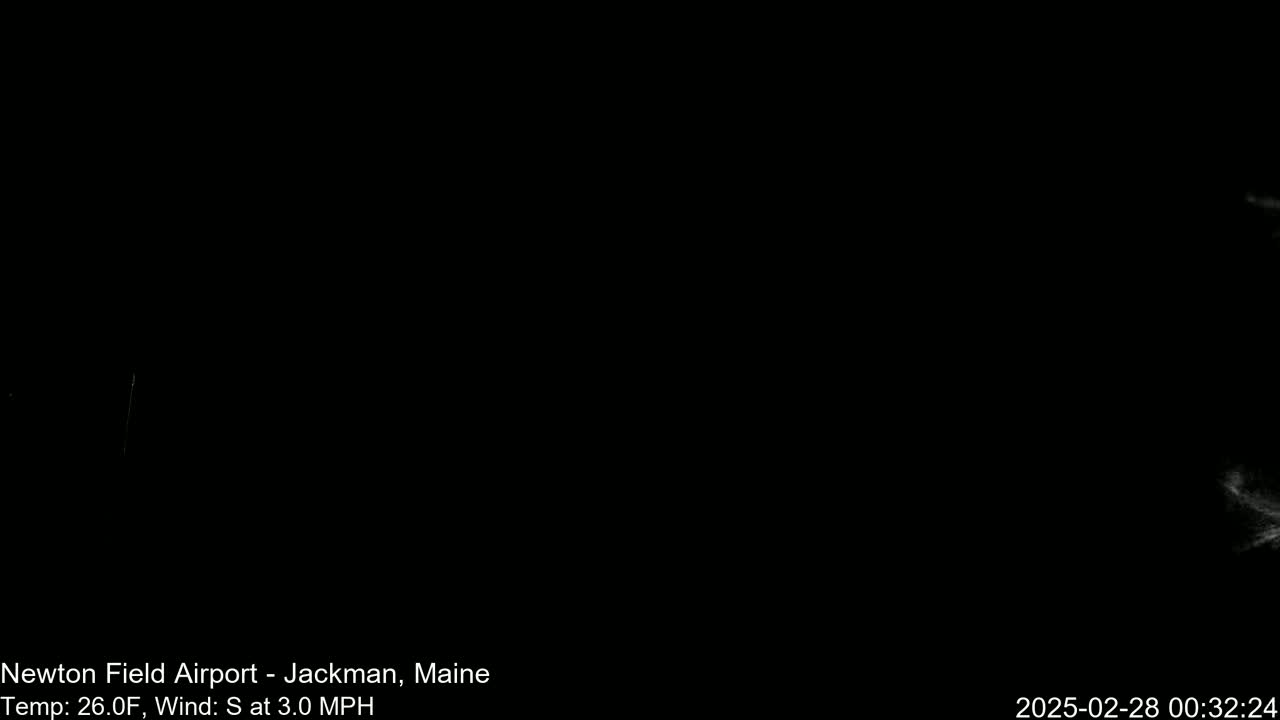 A mostly black image shows a dark, nighttime scene with faint light streaks in the distance and a 26°F temperature with a 3.0 mph south wind.