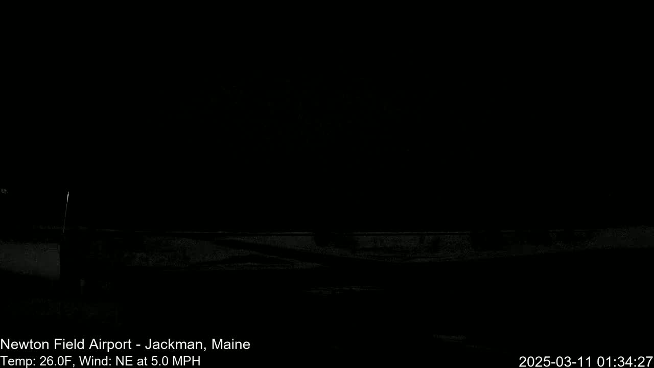 A dark, nighttime scene shows a low-lying horizontal structure under a clear, black sky with a northeast wind at 5.0 mph and a temperature of 26 degrees Fahrenheit.