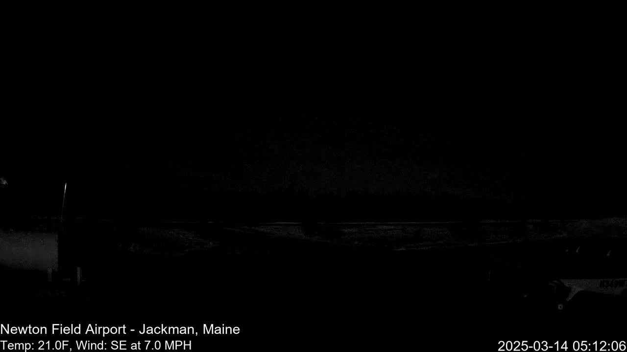 A dark, nighttime scene shows a flat, empty landscape under a black sky with a southeast wind.