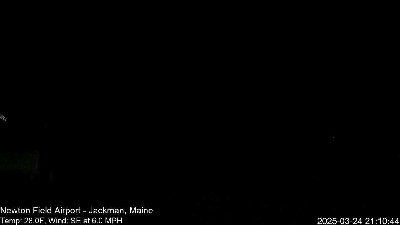 A completely dark nighttime scene with a faint light source in the upper left corner.