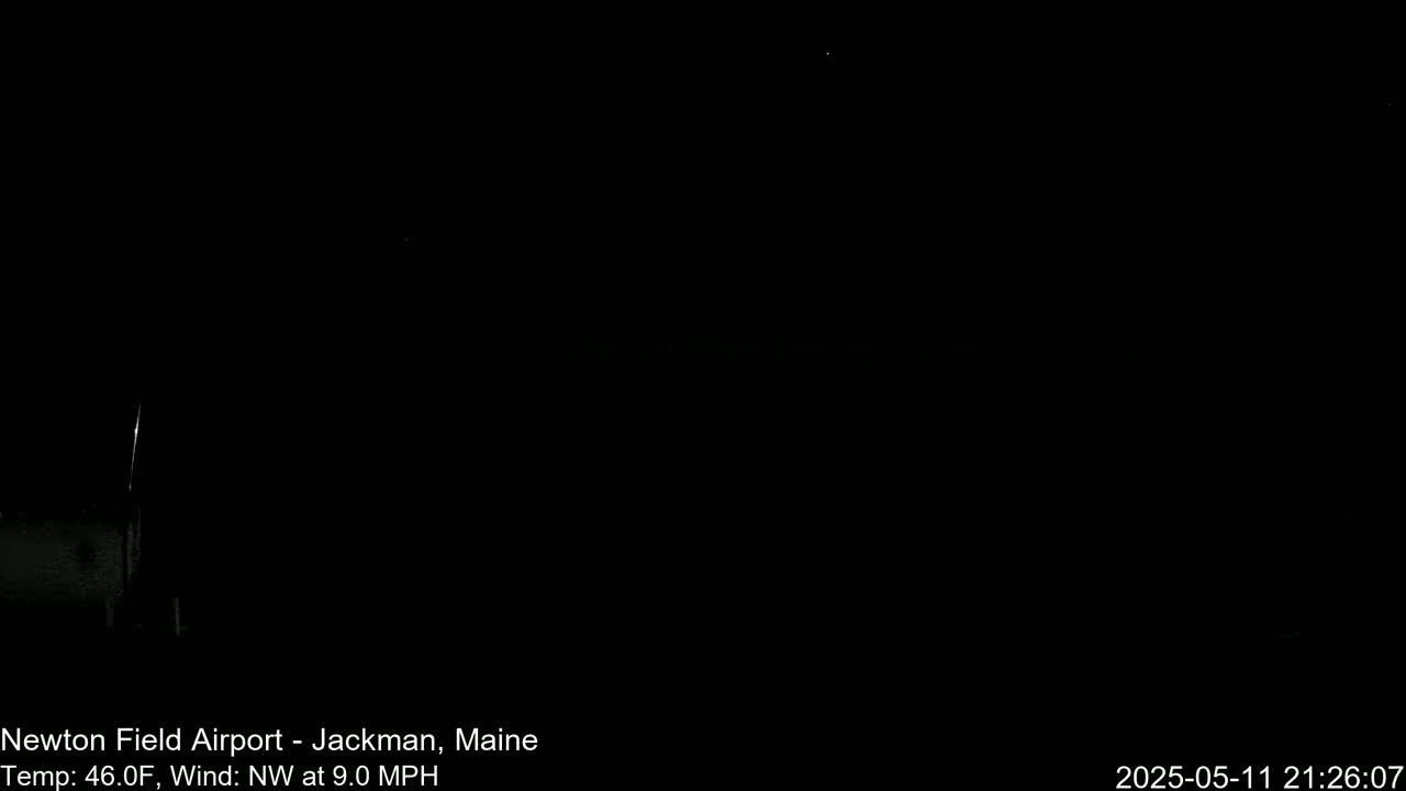 A mostly dark image shows a dimly lit area at night with a northwest wind at 9.0 mph and a temperature of 46.0°F.