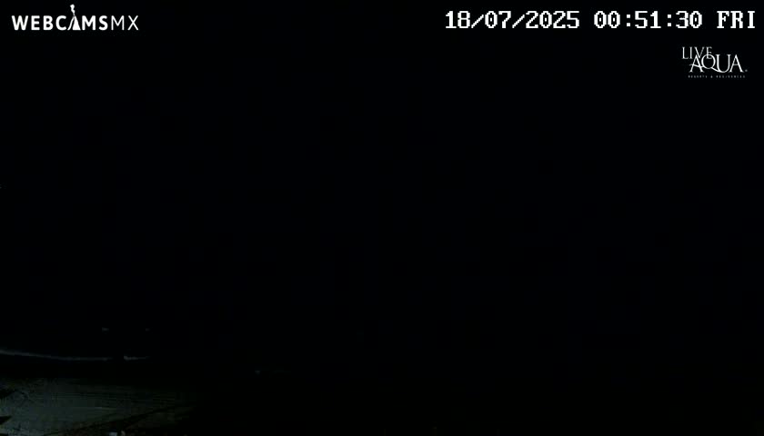 A nighttime outdoor scene is almost entirely dark, with only faint illumination near the bottom.