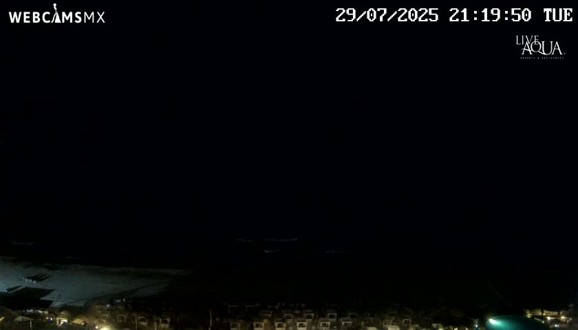 A nighttime outdoor scene is almost entirely dark, with only faint illumination near the bottom.