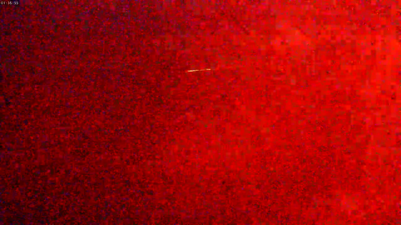A mostly red, grainy image shows a faint, thin, horizontal streak of light.