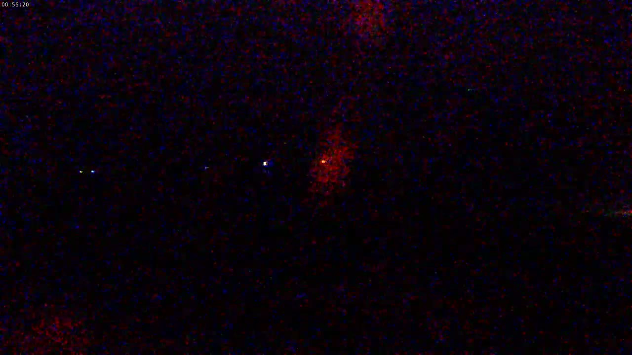 A dark night sky shows several stars and a larger, reddish celestial body.