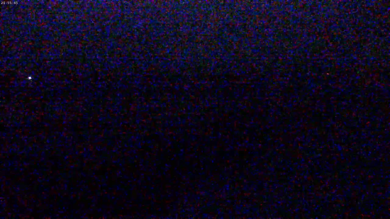 A nighttime image shows a dark, possibly star-filled sky with one bright point of light.