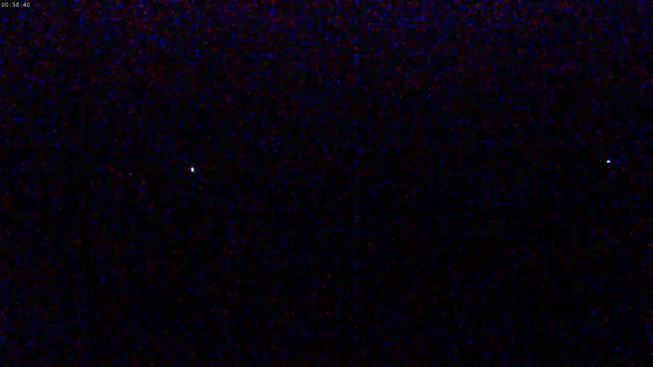 A dark, night sky shows three small, bright lights.