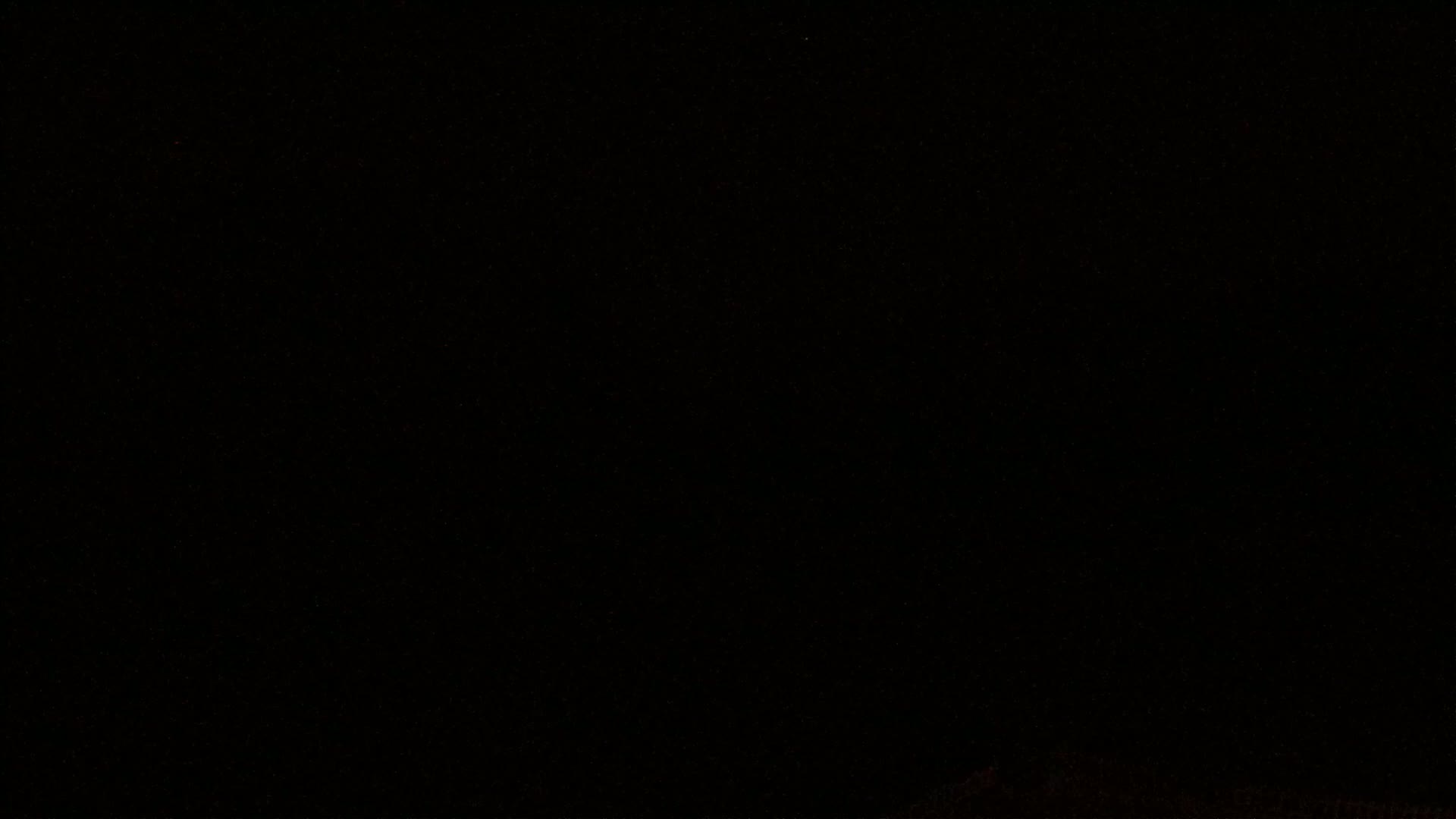 The image is predominantly black with a few barely visible specks of light.