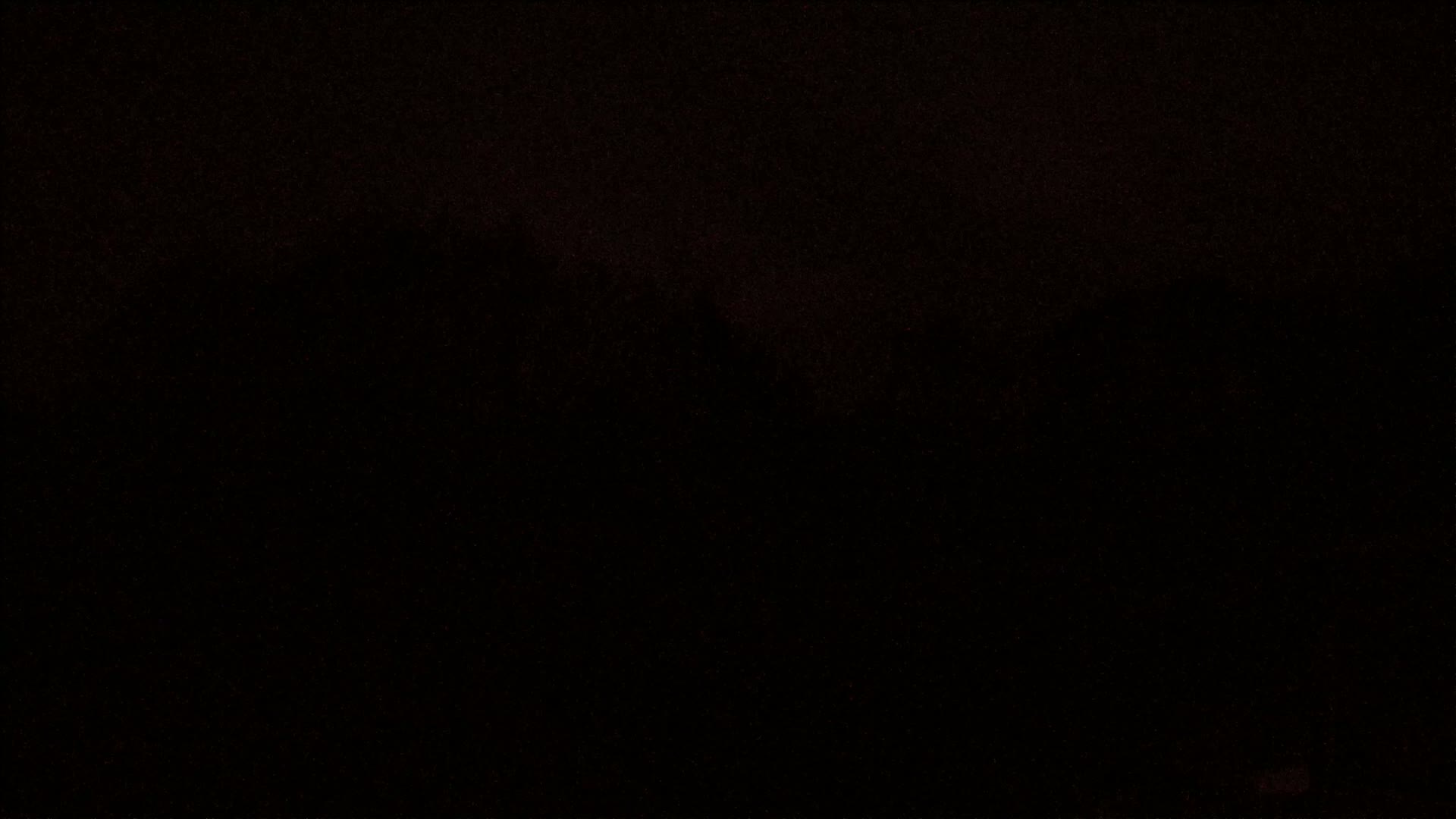 A dark, possibly nighttime, image shows a blurry, indistinct landscape.