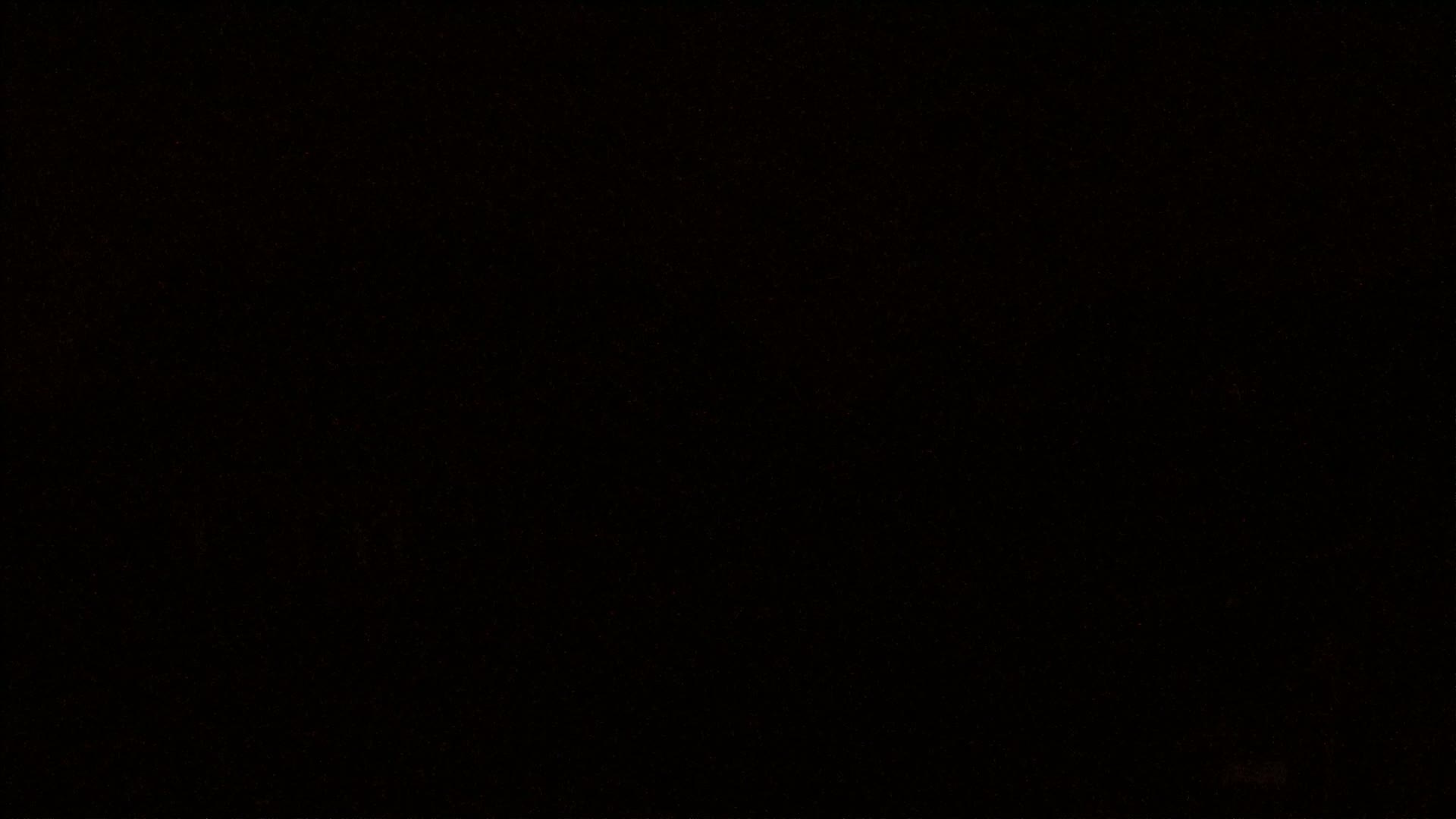 The image shows a completely black field with very faint speckles of light throughout.