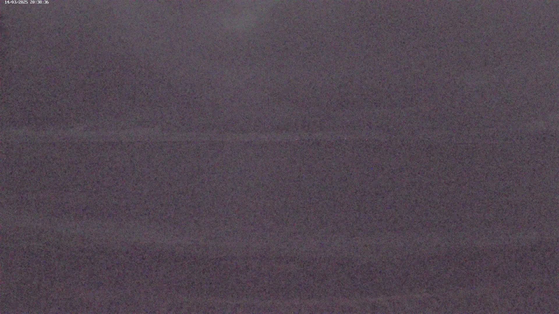 The image shows a dark gray, grainy surface.