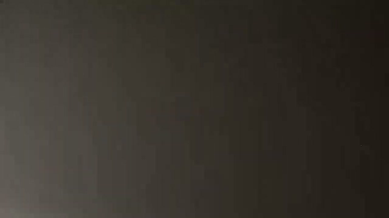 The image shows a dark gray or black surface.