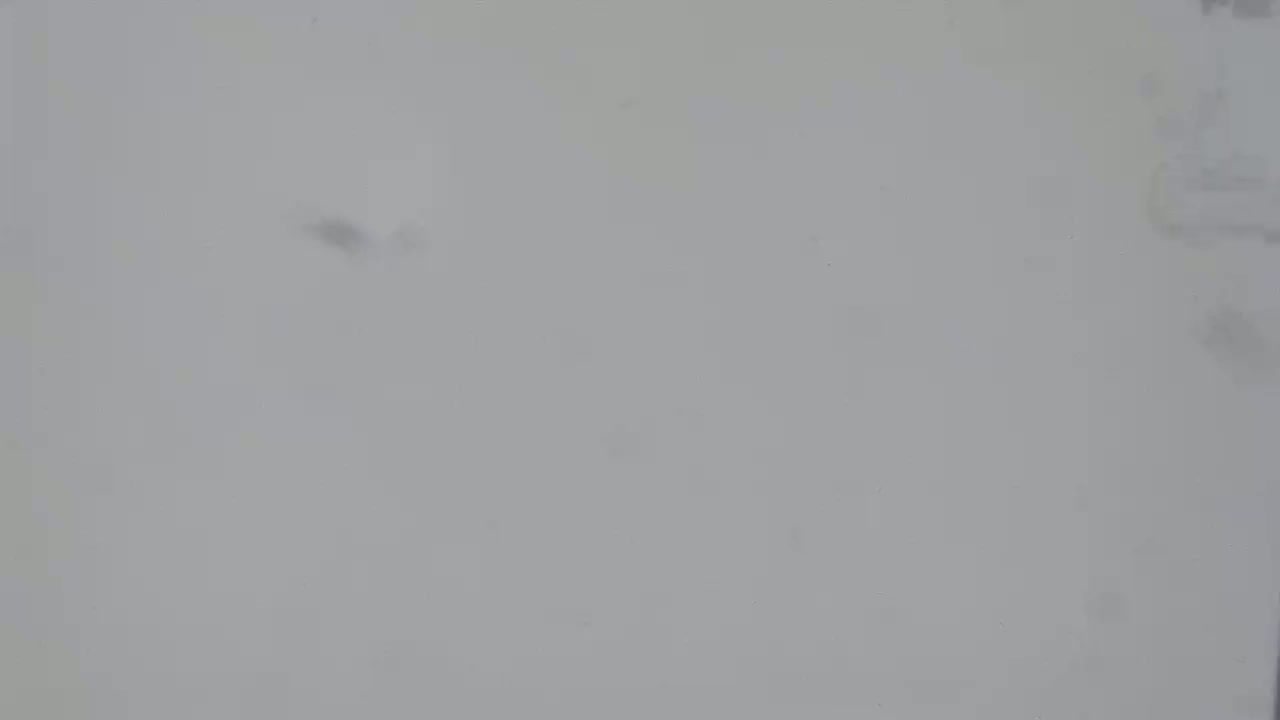 A blurry, light-grey surface is shown.