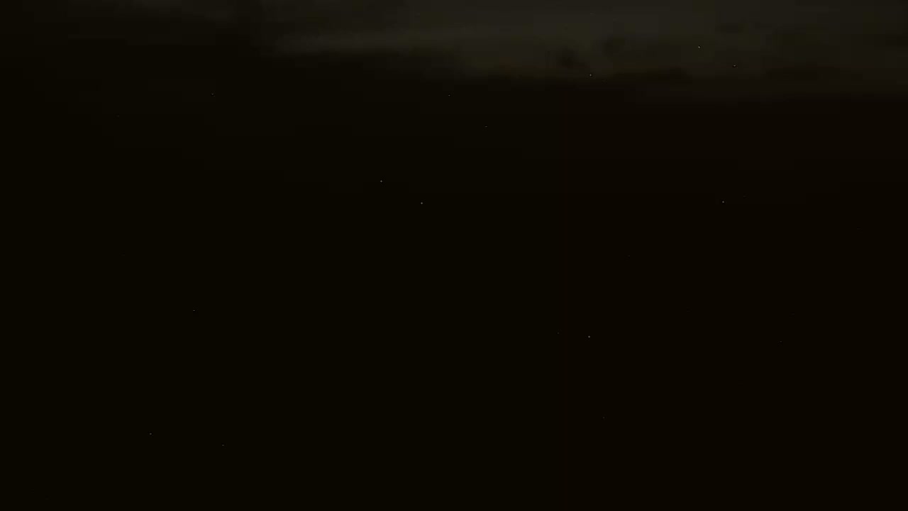 A dark, nighttime scene shows a few faint stars in the sky.