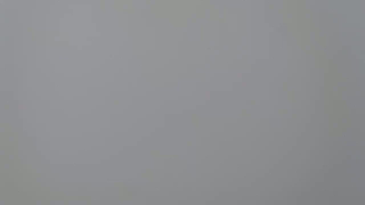 The image shows a solid, light gray background.