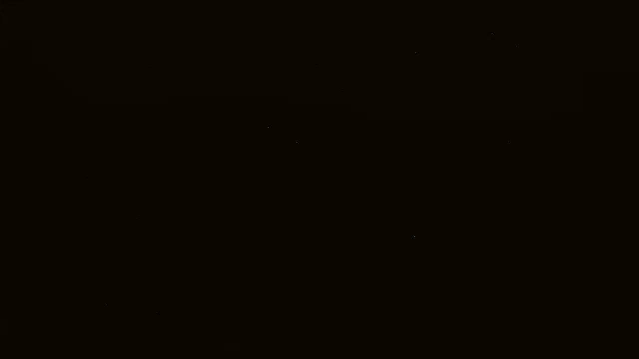 The image is a completely black picture with a few barely visible, extremely faint specks of light.