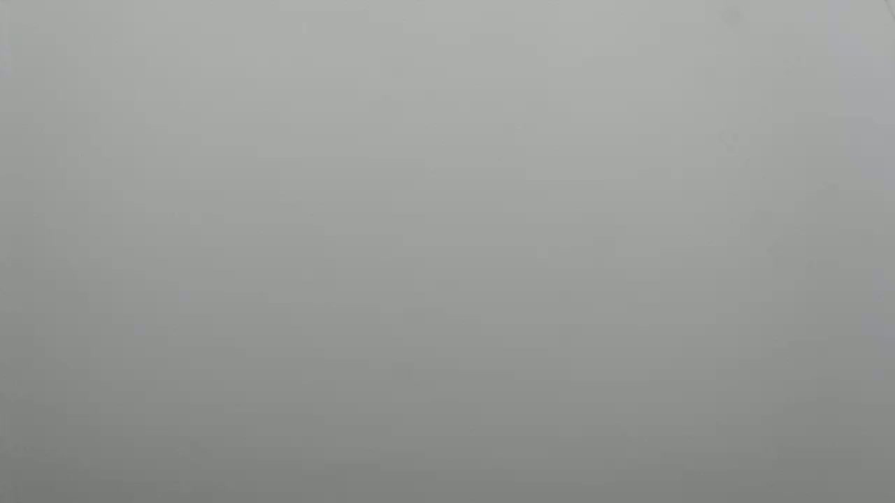 The image shows a solid, light gray background.