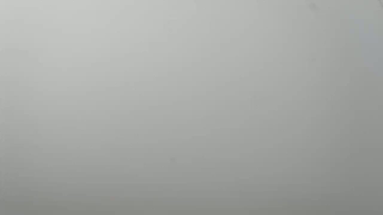 The image shows a uniformly light gray surface, appearing to be in foggy or hazy conditions.
