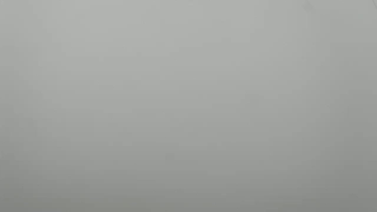 The image shows a solid, light gray background.