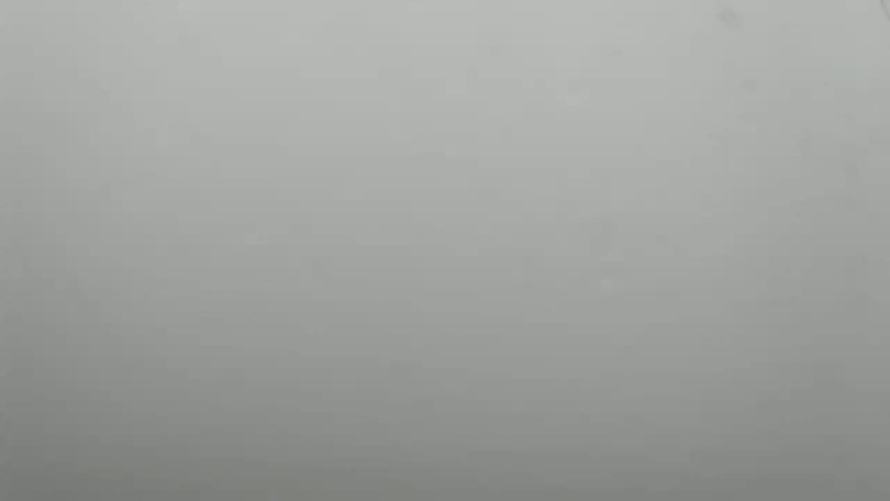 The image shows a solid, light gray background.