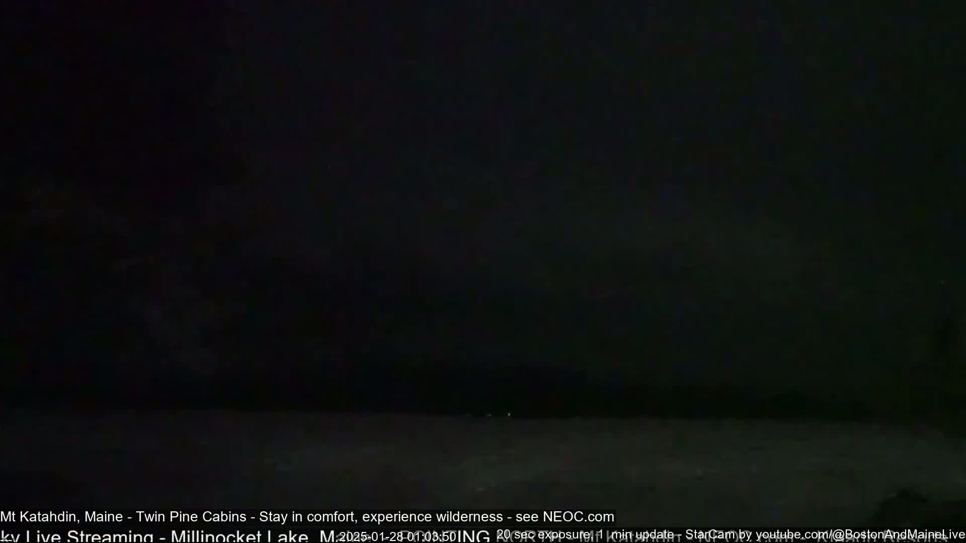 A dark, nighttime image shows a body of water under a mostly clear, dark sky.