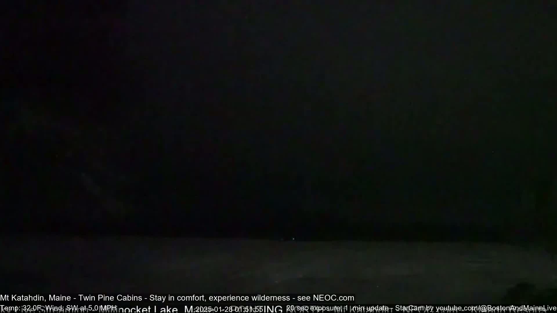 A very dark nighttime scene is shown with a faint, light area on the horizon.