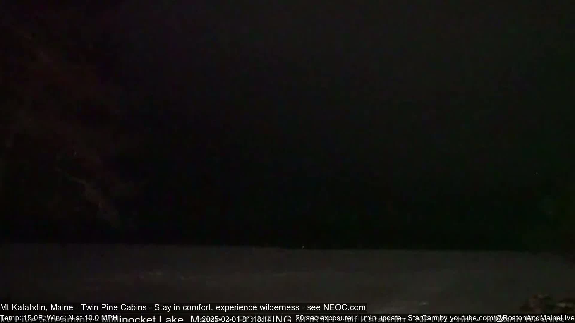 A dark, nighttime scene shows a body of water under a mostly clear, dark sky.