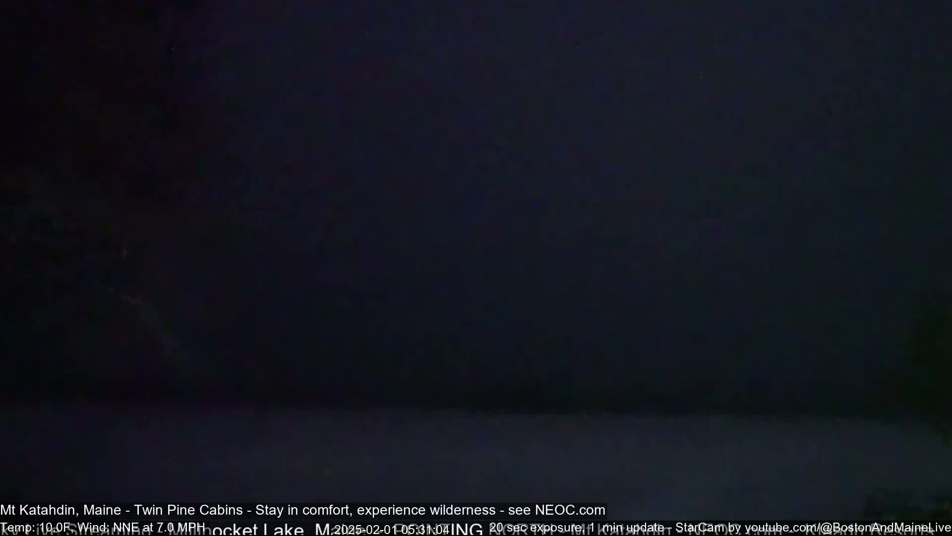 A dark, nighttime scene shows a mostly black sky and a dark, indistinct foreground.