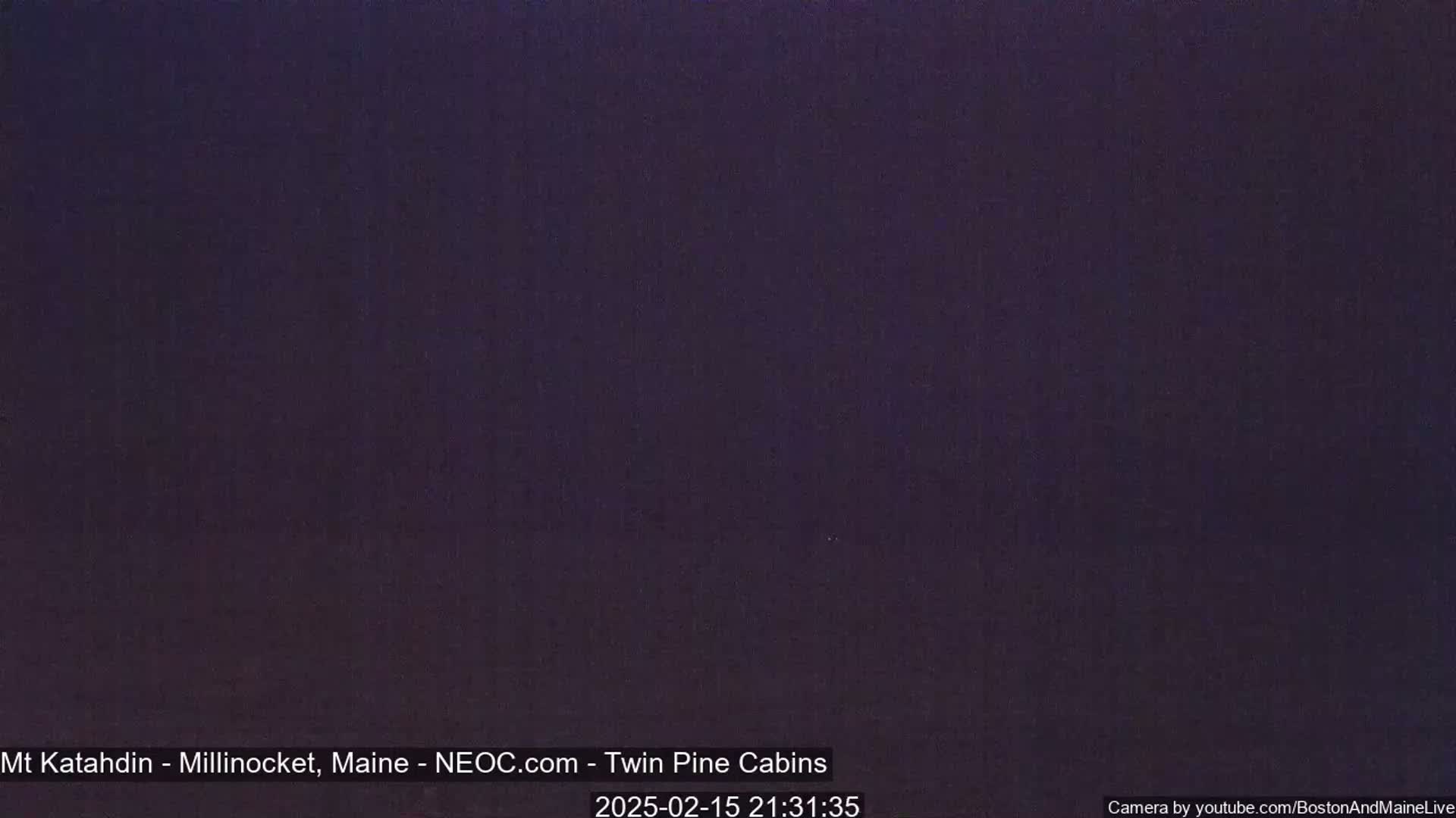 A dark, nighttime image shows a uniformly dark purple-black color.