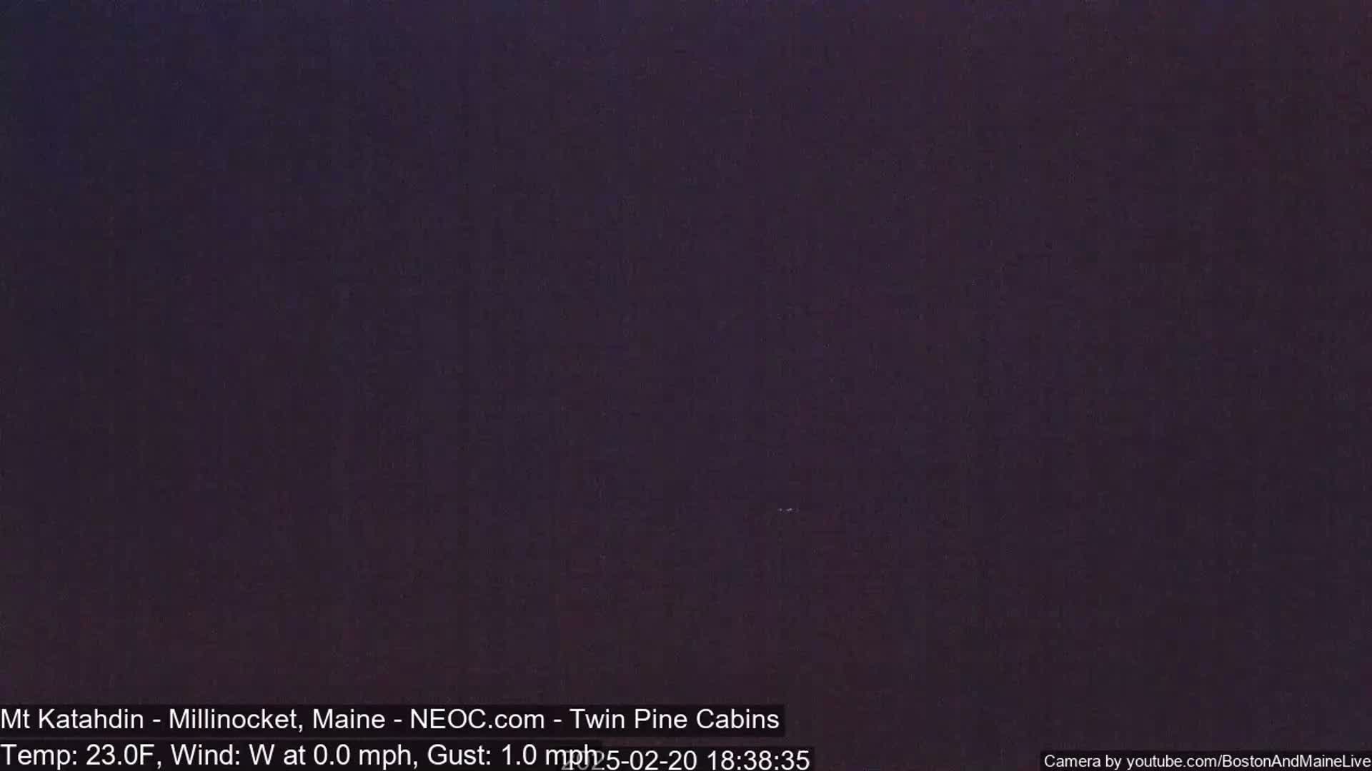 A dark, nighttime scene with a temperature of 23 degrees Fahrenheit and a light westerly wind.