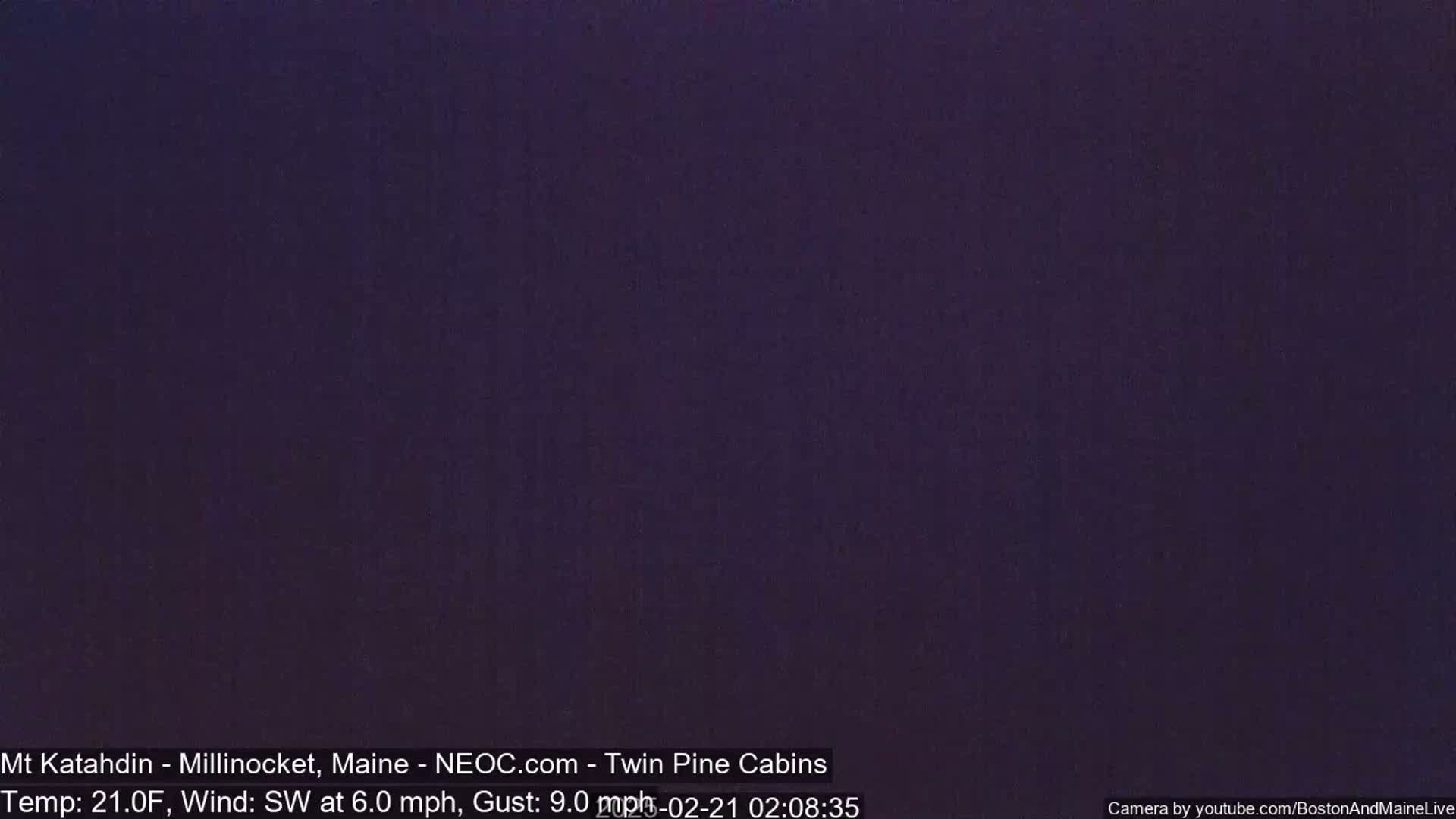 A dark purple screen shows a nighttime view with a southwest wind at 6 mph and gusts up to 9 mph, and a temperature of 21 degrees Fahrenheit.