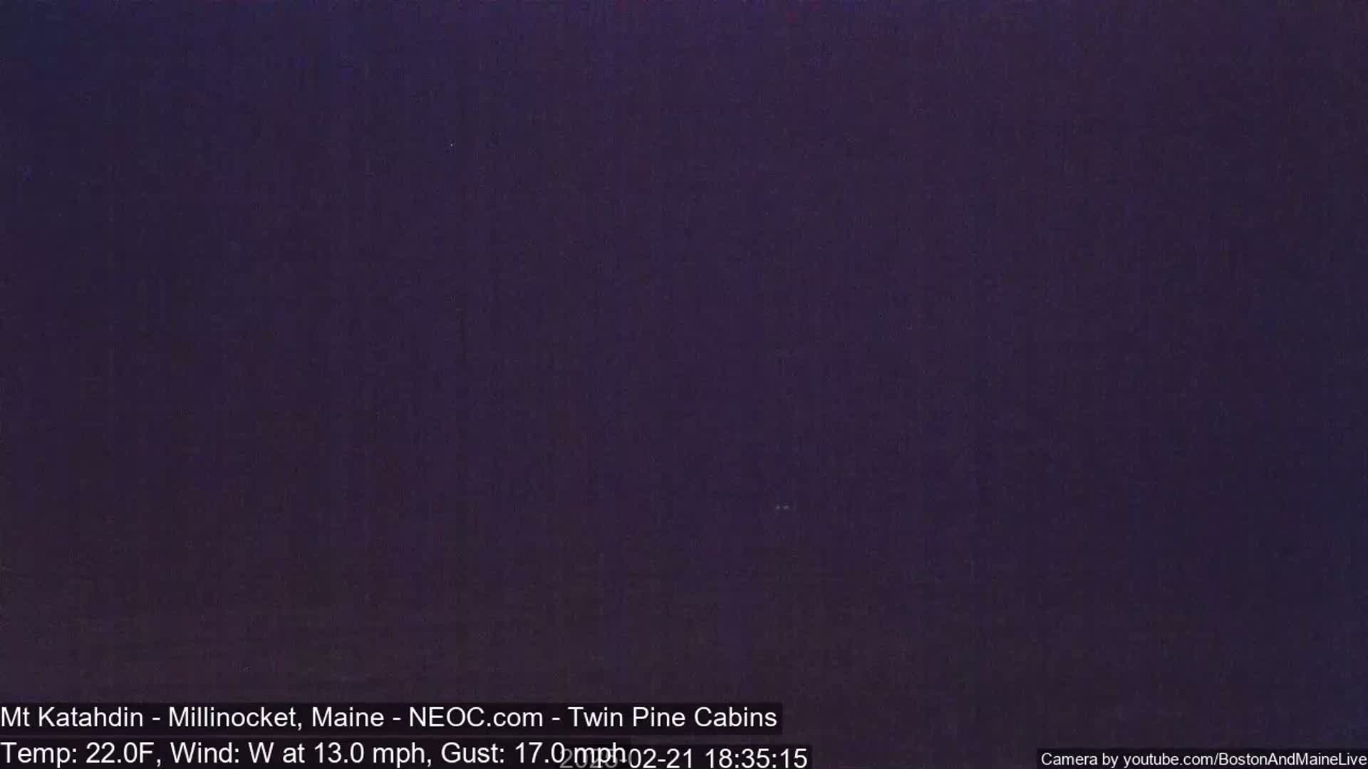 A dark purple-toned image shows a night scene with a temperature of 22 degrees Fahrenheit, a westerly wind at 13 mph, and gusts up to 17 mph.