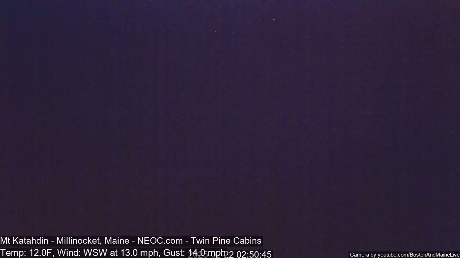 A dark, nighttime image shows a solid, dark purple or black screen.