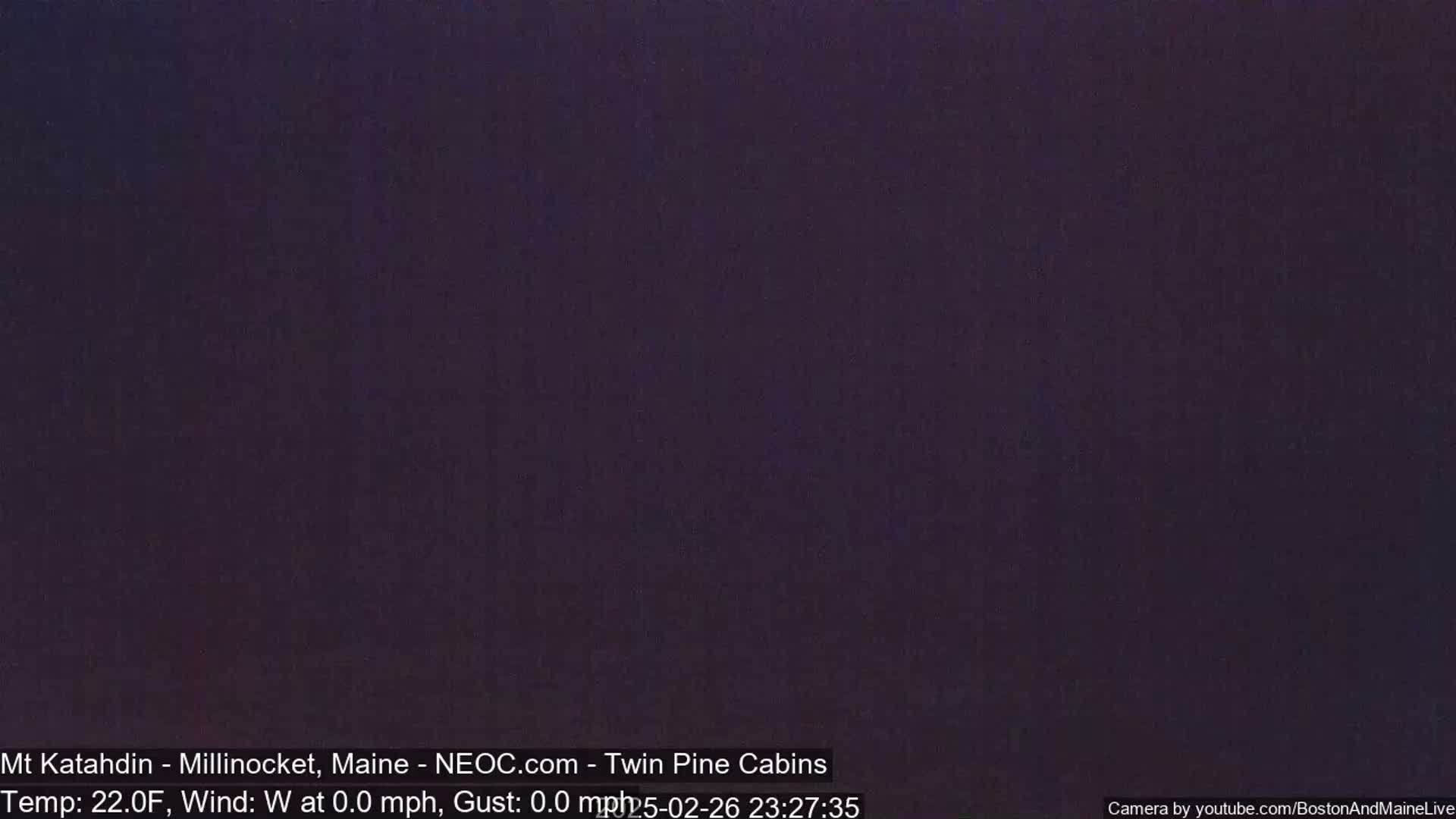 A dark, nighttime scene with calm weather conditions.
