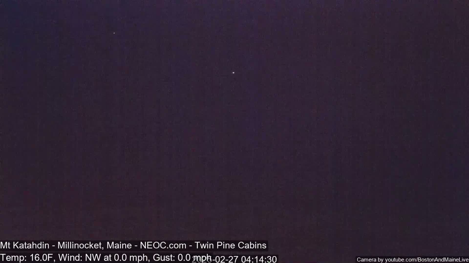 A dark, nighttime sky shows two bright stars.