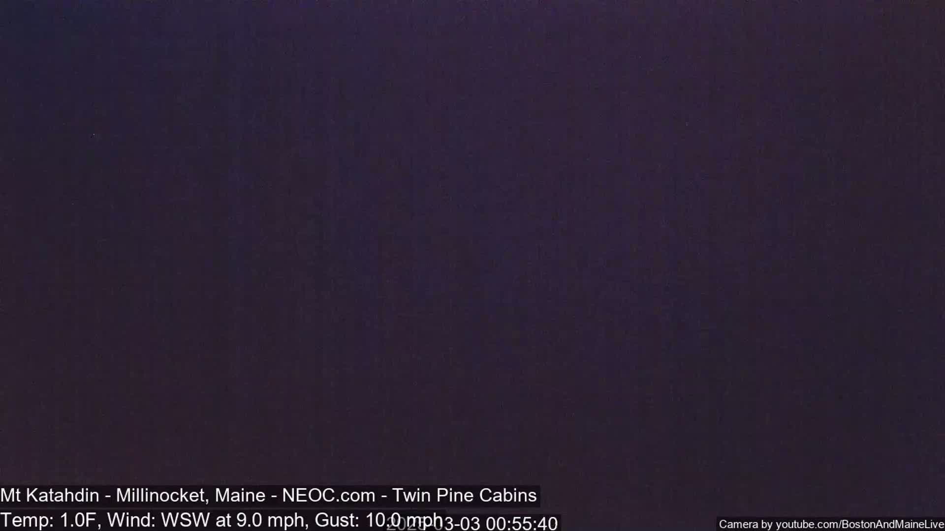 A dark, nighttime image shows a solid, dark purple screen.