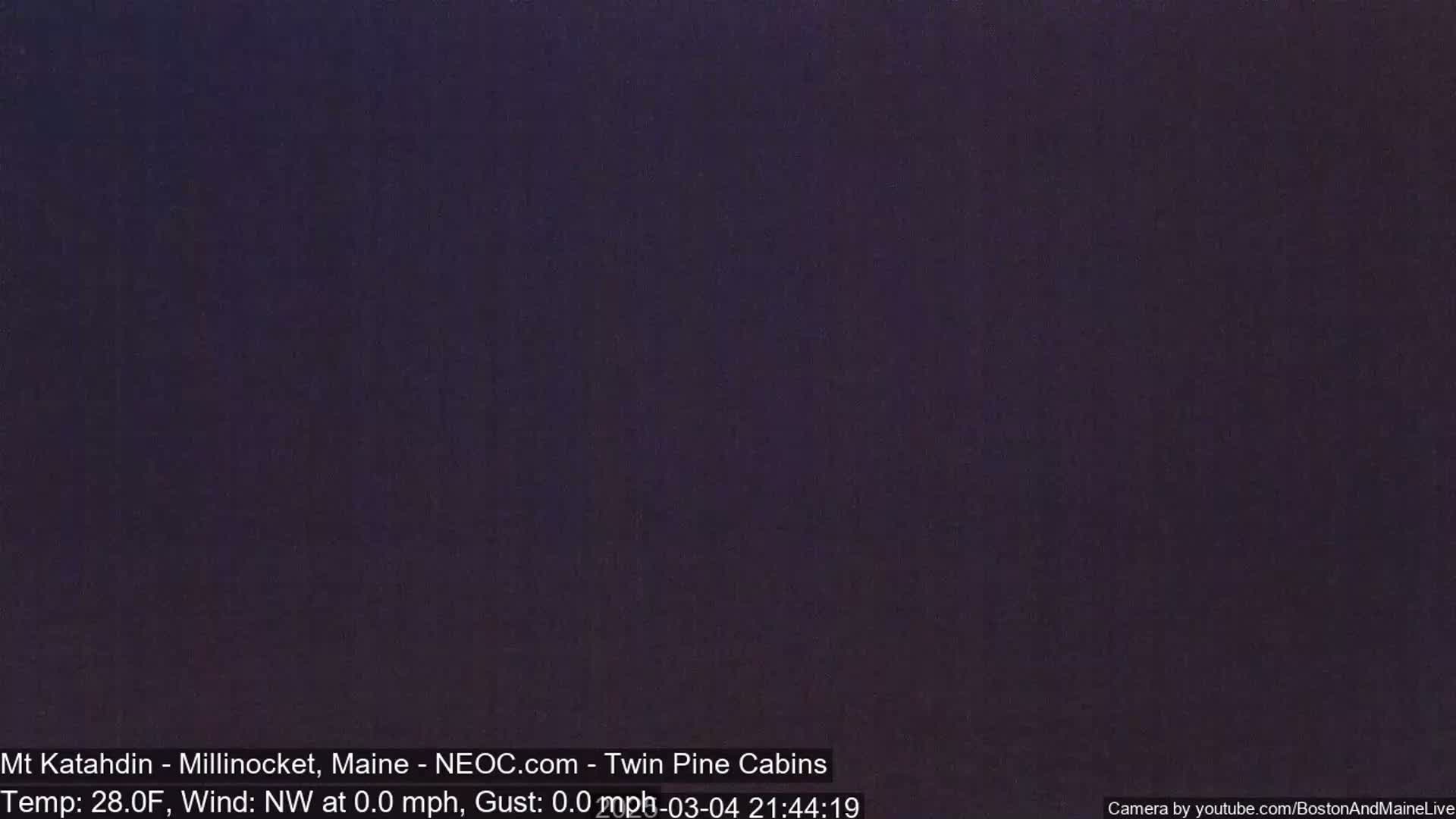 A dark, uniformly colored image showing a night scene with calm weather conditions.