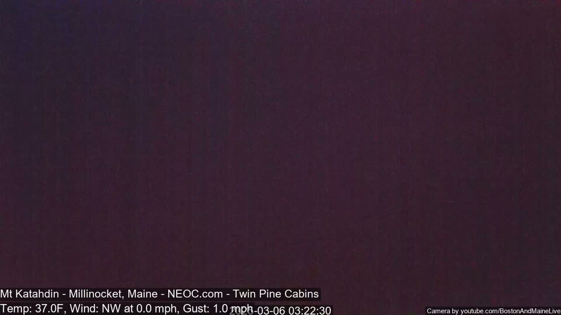 A dark purple-toned image shows a uniformly colored night sky with a temperature of 37°F and a northwest wind of 0.0 mph with gusts of 1.0 mph.