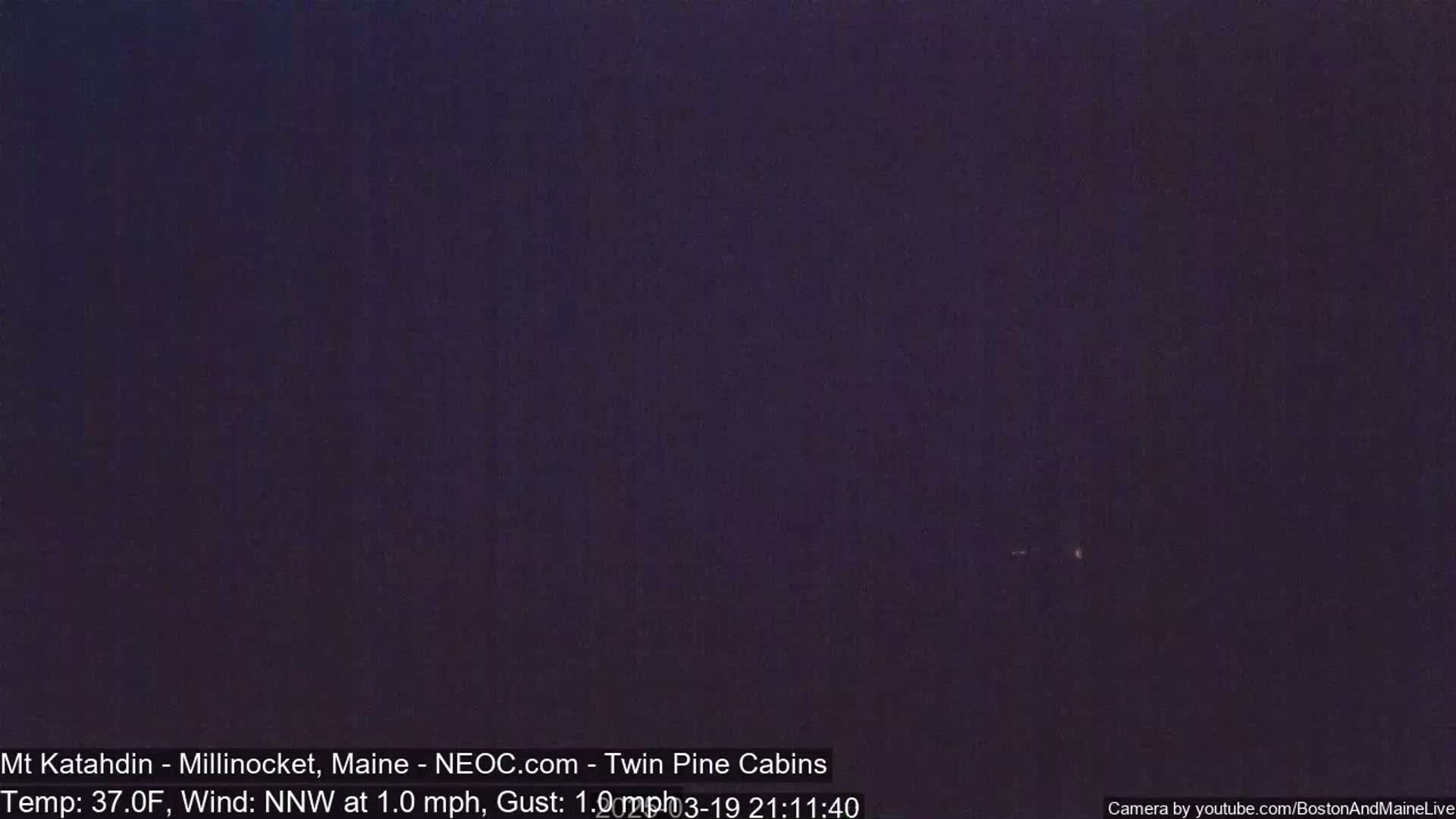 A dark, nighttime scene with a temperature of 37 degrees Fahrenheit and a light north-northwest wind.