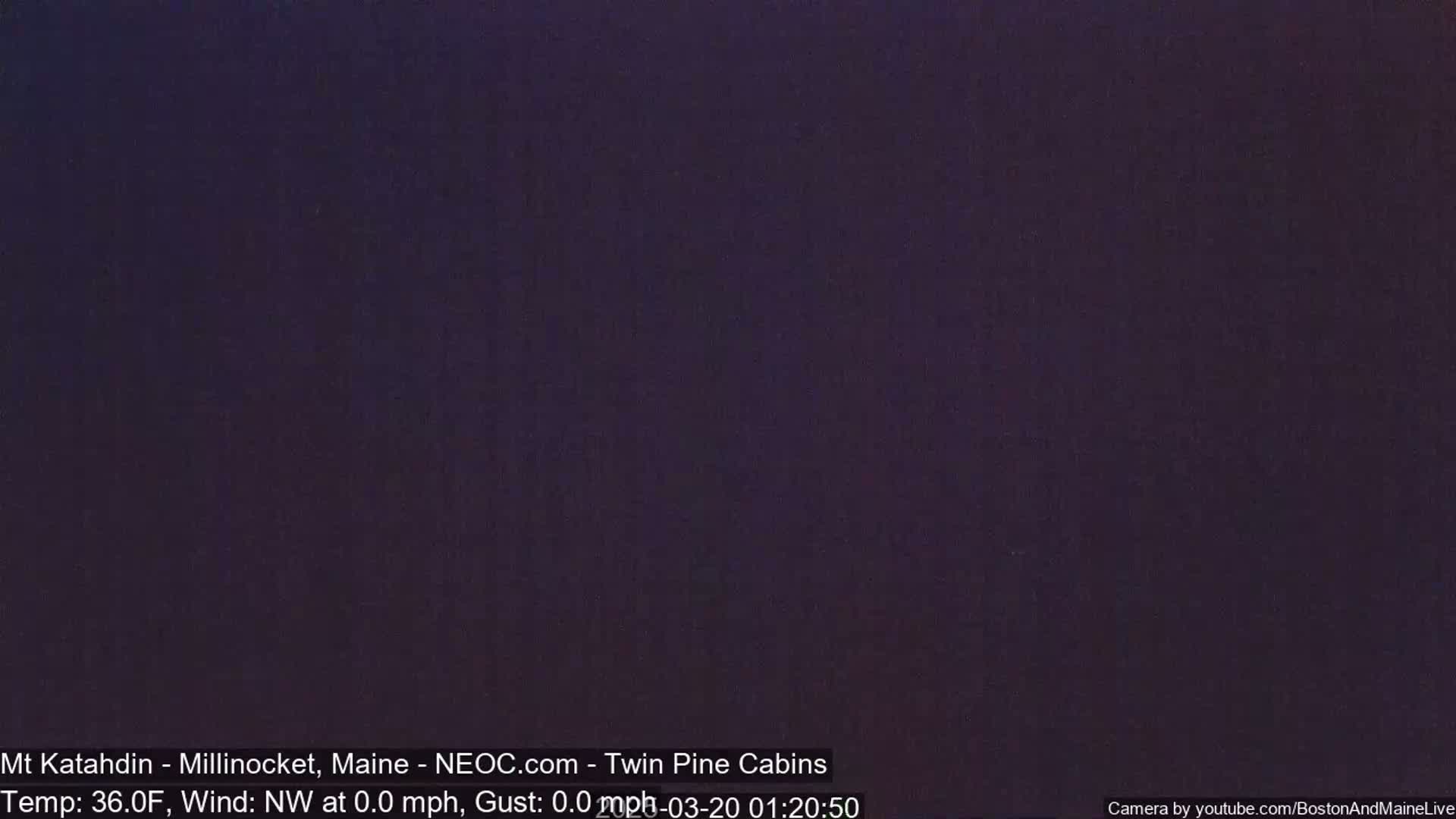 A dark, uniformly colored image shows a night scene with a temperature of 36 degrees Fahrenheit and a northwest wind at 0 mph.